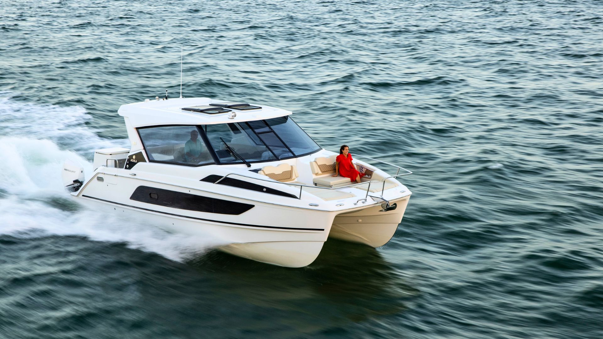 Catamaran sailing in the crystal clear sea of Baunei and Dorgali