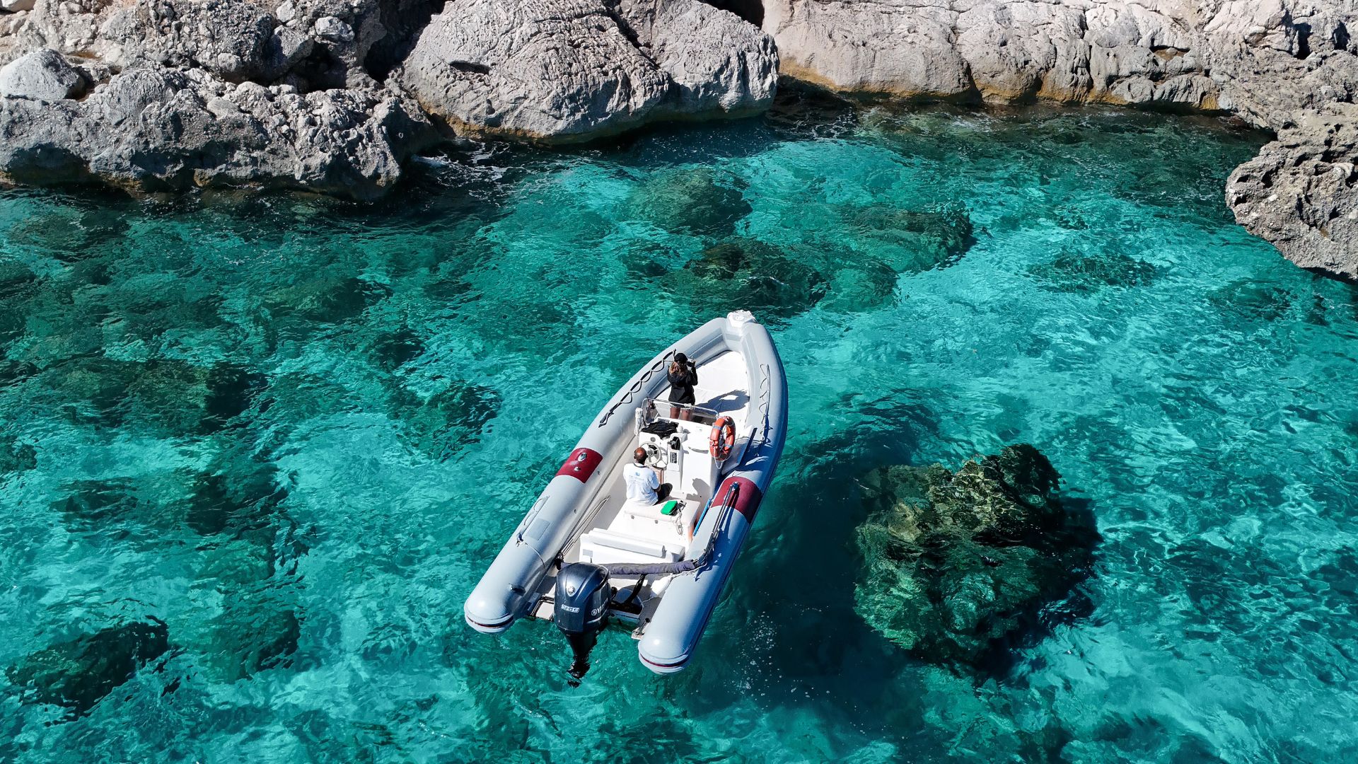 Dinghy sailing in the sea of Cala Gonone