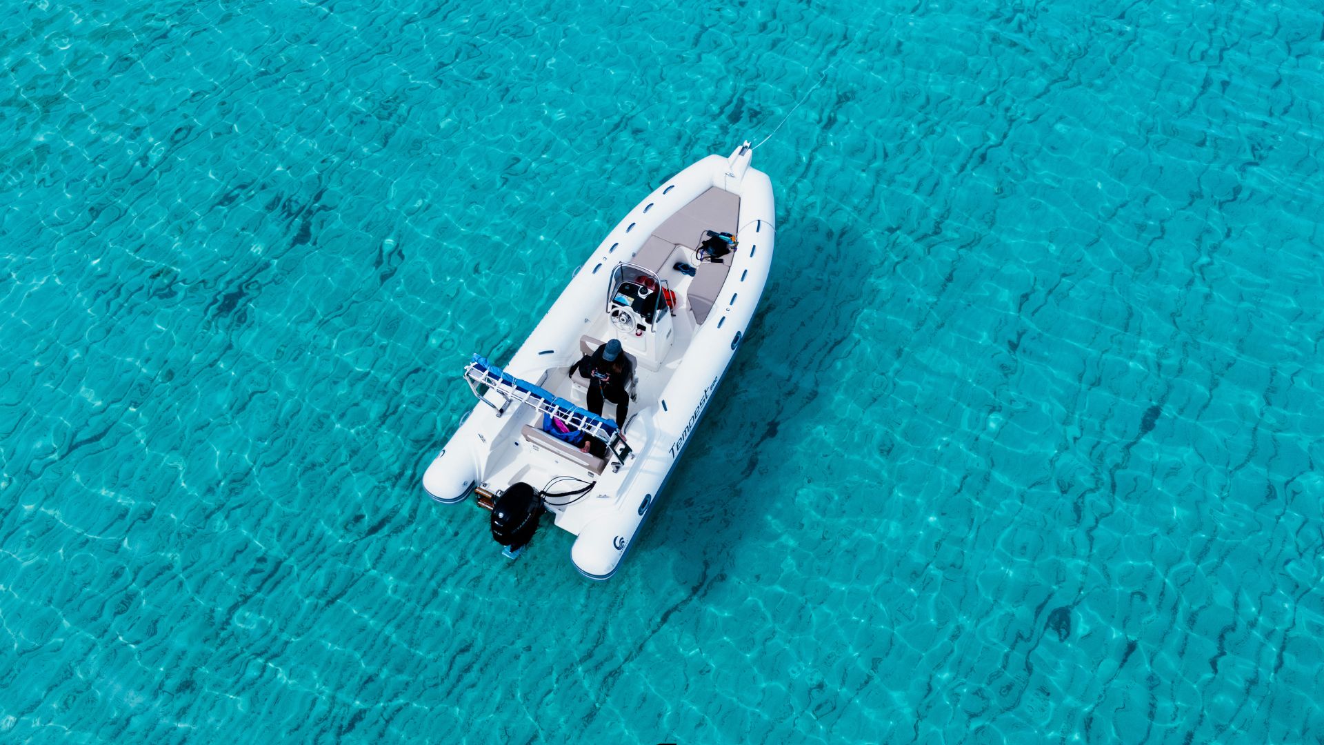 Dinghy sailing in the crystal clear waters of Cala Goloritzé